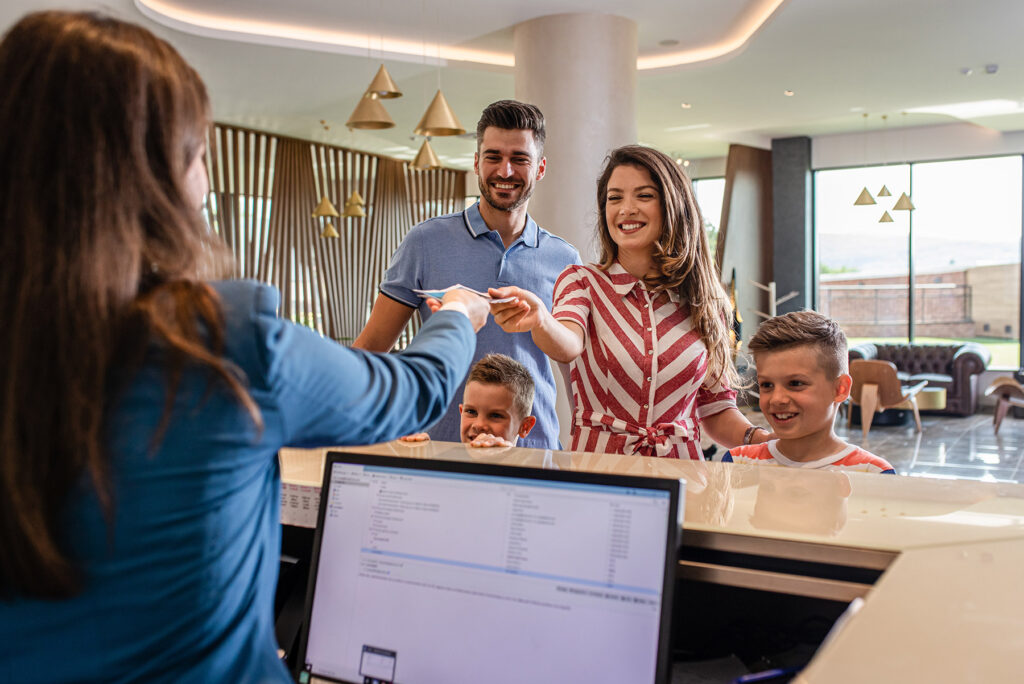 Hotel front desk with guests